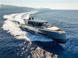 2025 Pardo Yachts GT75 cruising on open sea with scenic coastline in background.