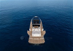 2025 Pardo Yachts GT75 on calm blue sea, rear view.