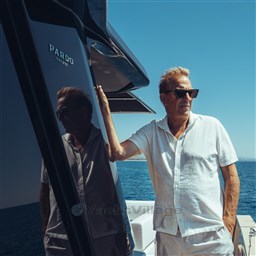 Man in white shirt on Pardo Yachts GT75, 2025 model, enjoying sunny day at sea.