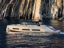 2025 Pardo Yachts GT75 cruising near rocky cliffs on a sunny day.