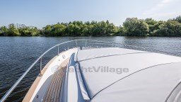 2024 Apreamare GOZZO 38 CABIN cruising on a serene lake with lush greenery.