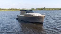 2024 Apreamare GOZZO 38 CABIN cruising on a serene lake.