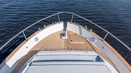 2024 Apreamare GOZZO 38 CABIN yacht bow with teak deck on calm water.