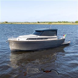 2024 Apreamare GOZZO 38 CABIN yacht on calm water, showcasing sleek design and modern features.