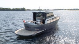 2024 Apreamare GOZZO 38 CABIN yacht on calm water, rear view.