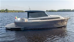 2024 Apreamare GOZZO 38 CABIN yacht on calm water, side view.