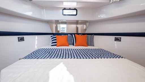 2024 Apreamare GOZZO 38 CABIN interior with stylish bedding and vibrant cushions.