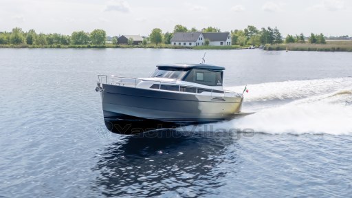 2024 Apreamare GOZZO 38 CABIN cruising on a serene lake with lush greenery.