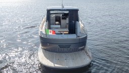 2024 Apreamare GOZZO 38 CABIN yacht on water, rear view with Italian flag.