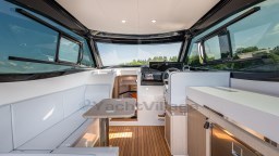 2024 Apreamare GOZZO 38 CABIN interior with modern seating and helm.