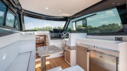 2024 Apreamare GOZZO 38 CABIN interior with modern design, featuring seating, table, and helm.