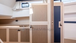 Interior of 2024 Apreamare GOZZO 38 CABIN with modern wood cabinetry and window.