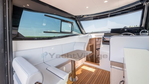 2024 Apreamare GOZZO 38 CABIN interior with white seating and wooden flooring.