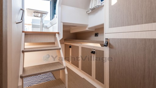 2024 Apreamare GOZZO 38 CABIN interior with wooden stairs and modern cabinetry.