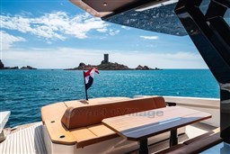 Luxurious 2024 Wider Wilder 60 yacht with scenic ocean view and island backdrop.