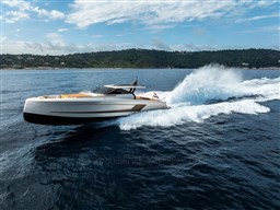 2024 Wider Wilder 60 yacht cruising on open sea under a partly cloudy sky.