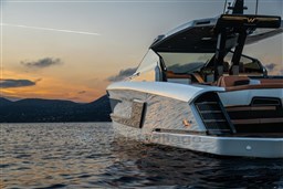 2024 Wider Wilder 60 yacht at sunset on calm waters.