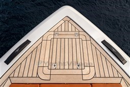 Bow of 2024 Wider Wilder 60 yacht with teak decking and sleek design.