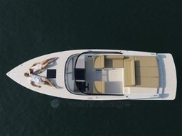 2025 VanDutch 32 yacht with two people relaxing on deck, aerial view.