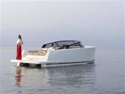2025 VanDutch 32 yacht on calm water with two people onboard.