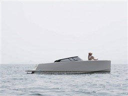 2025 VanDutch 32 yacht on calm sea with person relaxing on deck.