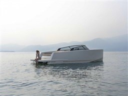 2025 VanDutch 32 yacht on calm water with a person sitting at the stern.