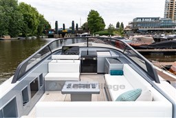 Luxurious 2024 VanDutch 40 yacht with sleek design and spacious seating on a serene waterway.