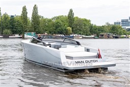 2024 VanDutch 40 yacht cruising on a serene river with lush greenery in the background.