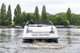 2024 VanDutch 40 yacht cruising on a serene river with lush green trees.