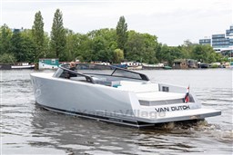 2024 VanDutch 40 yacht cruising on a serene river with lush greenery.