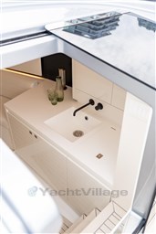 Modern interior of 2024 VanDutch 40 yacht featuring sleek white sink and minimalist design.
