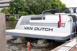 2024 VanDutch 40 yacht on water, rear view with flag, sleek design.