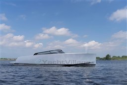 2024 VanDutch 40 yacht on calm water under a blue sky with clouds.