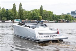 2024 VanDutch 40 yacht cruising on a serene river with lush greenery in the background.