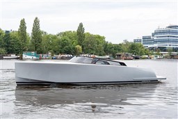 2024 VanDutch 40 yacht on a serene river, modern design, surrounded by lush greenery and buildings.