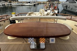 Luxury Fratelli Aprea 50 yacht deck with wooden table, docked in marina, 2007 model.