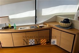 Interior of 2009 Pershing 72 yacht with wooden cabinets and decorative items.
