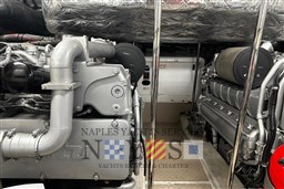Engine room of a 2009 Pershing 72 yacht, showcasing detailed machinery components.