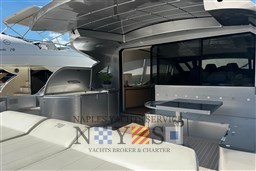 Luxurious 2009 Pershing 72 yacht with sleek outdoor seating and modern design.