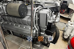 Engine room of a 2009 Pershing 72 yacht, showcasing a powerful marine engine.