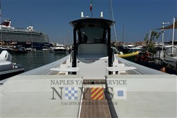 2020 Magazzu MX 13 Gran Coupè yacht docked in a marina, with cruise ship in background.