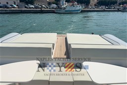 2020 Magazzu MX 13 Gran Coupè yacht deck with seating, docked by the water.