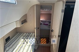 Interior cabin of 2020 Magazzu MX 13 Gran Coupè with striped bedding.