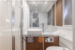 Luxurious bathroom interior of 2024 Itama 62 RS yacht with modern fixtures and wood accents.