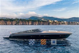 2024 Itama 62 RS yacht cruising near scenic coastal cliffs.