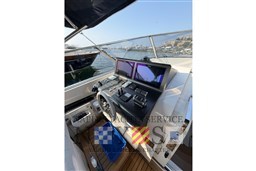 Helm of 2024 Itama 62 RS yacht with modern navigation controls and dual screens.