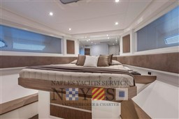 Luxurious interior of 2024 Itama 62 RS yacht with elegant bedding and modern design.