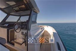 2022 Bluegame BG 42 yacht cockpit with ocean view, featuring sleek design and modern controls.
